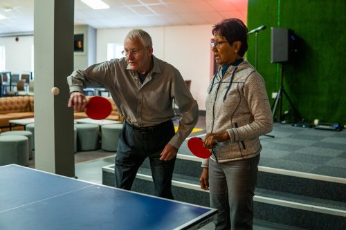 To eldre personer står klare ved e bordtennisbord